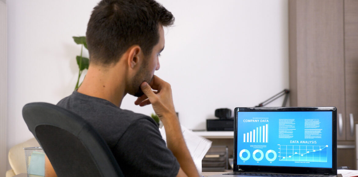 Business man with beard working hard at his desk in the office. Business man with beard working hard at his desk in the office. Motivated young man .