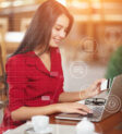 Business woman pays for a purchase with credit card. Beautiful girl in red shirt makes a purchase on the Internet. Buy and shopping online. Business infographic